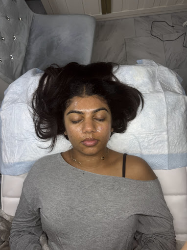 A woman laying in a hospital bed with her eyes closed