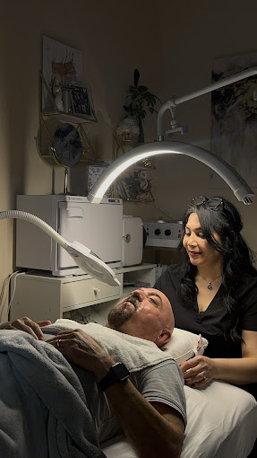 A man laying in a hospital bed next to a woman