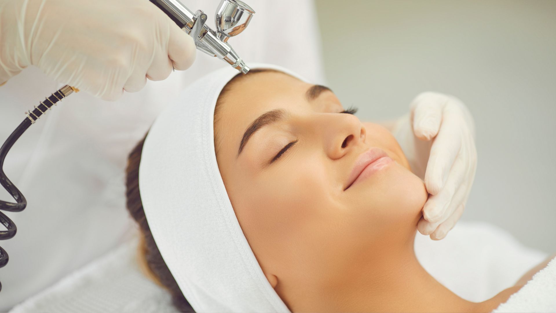 A woman getting a facial massage at a beauty salon